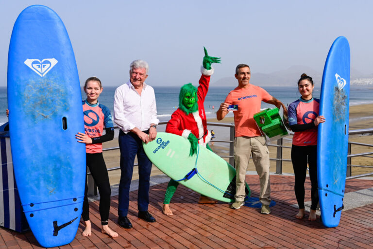 El Grinch de la Navidad surfea Las Canteras con espíritu solidario